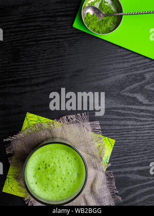 Matcha powder explosion and Matcha latte in glass made from finely ground green tea powder. It's very common in japanese culture. Matcha is healthy du Stock Photo