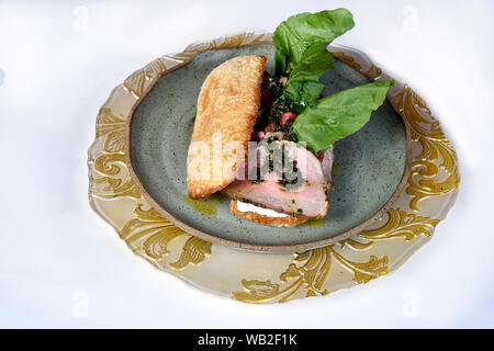 beef sandwich with rucula, cherry tomatoes and pesto. Stock Photo