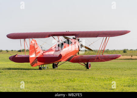 A red Biplane on the field in Martha's Vineyard Stock Photo