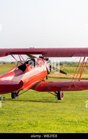 A red Biplane on the field in Martha's Vineyard Stock Photo