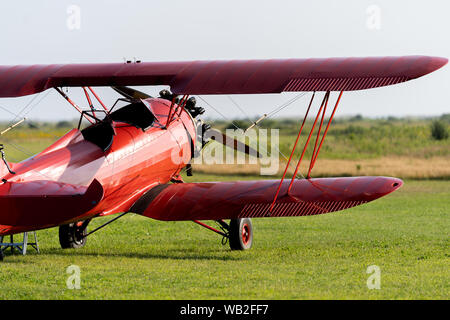 A red Biplane on the field in Martha's Vineyard Stock Photo