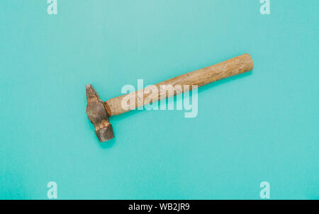 Old hammer isolated on electric green background. Flat layout. Stock Photo