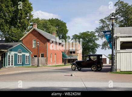 Dearborn, Michigan, USA. 17th Aug, 2019. Aug 17, 2019, Dearborn, Michigan, United States; A Model T rolls around the streets of Greenfield Village, a history museum with period buildings and Historic places which were relocated such as Thomas Edison's Menlo Park research facility and the Wright Brothers Cycle Shop and home all on a campus created by the car magnate Henry Ford and first opened in 1929 in Dearborn, Michigan. Credit: Ralph Lauer/ZUMA Wire/Alamy Live News Stock Photo