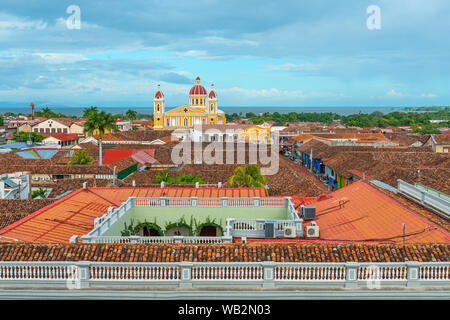 Cityscape of Granada city with its colorful yellow cathedral, spanish colonial style architecture and the Nicaragua lake in the background, Nicaragua. Stock Photo