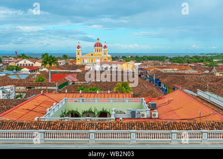 Cityscape of Granada city with its colorful yellow cathedral, spanish colonial style architecture and the Nicaragua lake, Nicaragua. Stock Photo