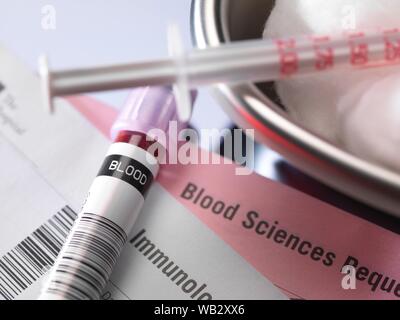 Human blood sample alongside blood test request form. Stock Photo
