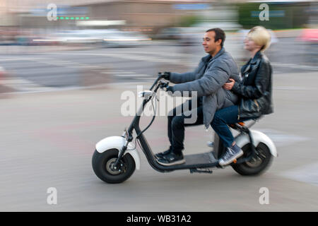 Couple on an electric scooter in Minsk, Belarus. Stock Photo