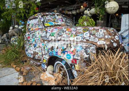 KEY WEST, FLORIDA, USA - JANUARY 14, 2019: A disused vintage truck plastered with decals and bumper stickers stands in the Old Town tourist district. Stock Photo