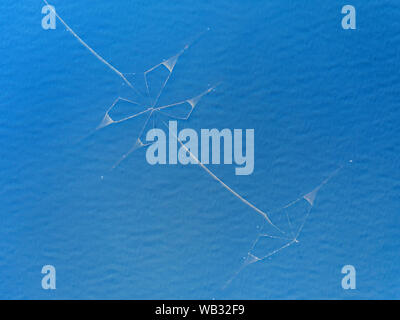 Fishing nets in the deep blue sea top aerial view Stock Photo