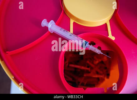 Augsburg, Germany. 16th July, 2019. In the addict's meeting place there are used drug syringes in a collection container. The Social Service of Catholic Men (Sozialdienst katholischer Männer, SKM), together with the drug help service, runs the 'Subject' point at Oberhauser Bahnhof. Credit: Stefan Puchner/dpa/Alamy Live News Stock Photo