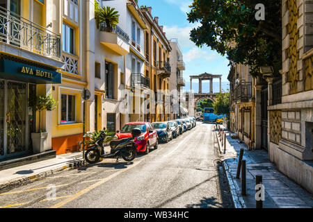 View from a quiet street as traffic passes by The Arch of Hadrian, known in Greek as Hadrian's Gate in the historic center of Athens, Greece Stock Photo