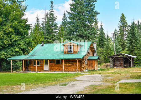 An abandoned log cabin in the rural mountains of North Idaho Stock Photo