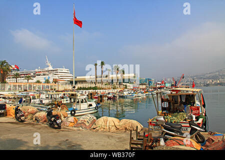 Marina in Kusadasi, Turkey with Fisherman Mending Nets Stock Photo