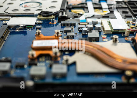 Technician repairing broken laptop notebook computer with screwdriver Stock Photo
