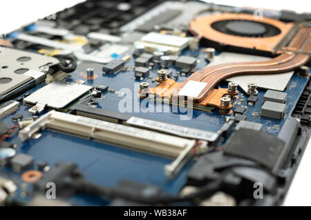 Technician repairing broken laptop notebook computer with screwdriver Stock Photo