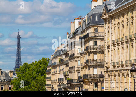 Eiffel tower between Parisian tenement old street alley and buildings, Paris Stock Photo