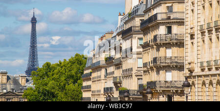 Eiffel tower between Parisian tenement old street alley and buildings, Paris Stock Photo