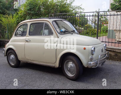 MASSA CARRARA, ITALY - AUGUST 1, 2019: An original style Fiat 500 car parked in a residential street, now become a symbol of Italian style and culture Stock Photo