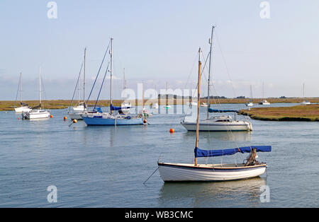 Dinghies, yachts, and sailboats, anchored in the east channel in the port of Wells-next-the-Sea, Norfolk, England, United Kingdom, Europe. Stock Photo