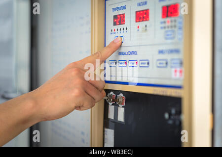 Man hand the controls of a modern machine Stock Photo