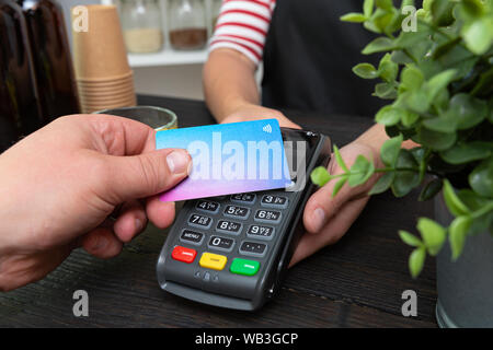 Customer making wireless or contactless payment using credit card Stock Photo