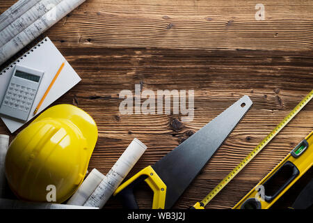 Construction and renovation concept. Building contractor tools on wooden table. Top view. Stock Photo