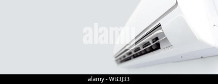 Air conditioner split hanging on the wall. Cooling device in room. Stock Photo