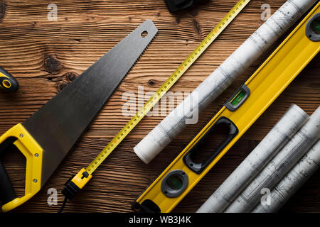Construction and renovation concept. Building contractor tools on wooden table. Top view. Stock Photo