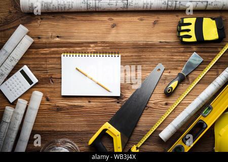 Construction and renovation concept. Building contractor tools on wooden table. Top view. Stock Photo
