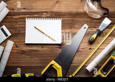 Construction and renovation concept. Building contractor tools on wooden table. Top view. Stock Photo