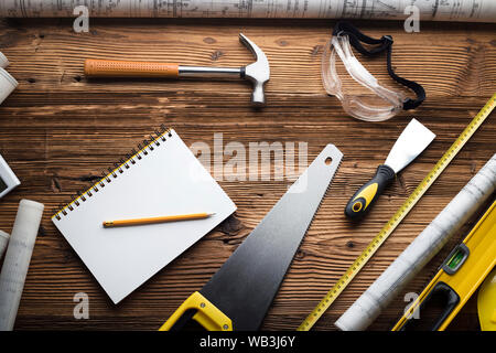 Construction and renovation concept. Building contractor tools on wooden table. Top view. Stock Photo