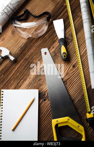 Construction and renovation concept. Building contractor tools on wooden table. Top view. Stock Photo