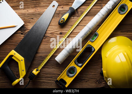 Construction and renovation concept. Building contractor tools on wooden table. Top view. Stock Photo