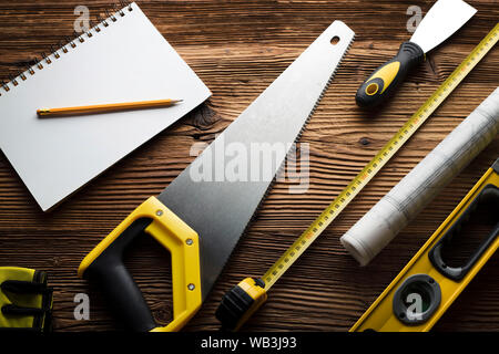 Construction and renovation concept. Building contractor tools on wooden table. Top view. Stock Photo