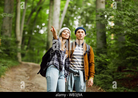 View of the woman pointing something on the forest and the man with surprised expression Stock Photo