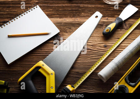 Construction and renovation concept. Building contractor tools on wooden table. Top view. Stock Photo