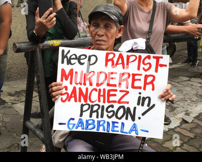 Manila, Philippines. 23rd Aug, 2019. A protester holds a placard in front of the Department of Justice during the demonstration.GABRIELA Alliance of Women, together with other women formations, held a protest in front of the Department of Justice in Manila to show their opposition to any move to release former Calauan, Laguna Mayor Antonio Sanchez from prison under RA 10592, a new law that adjusts the Good Conduct Time Allowance rule under the Revised Penal Law. Credit: SOPA Images Limited/Alamy Live News Stock Photo
