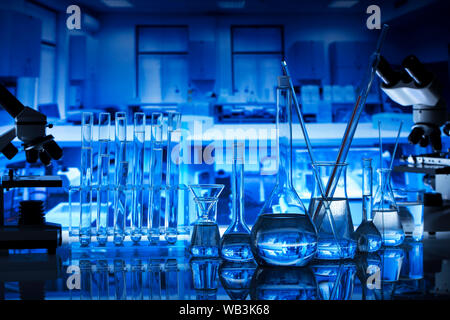Science laboratory concept background. Microscope and laboratory glassware composition. Stock Photo