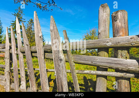 Wooden fence of planks in the country on a sunny day Stock Photo