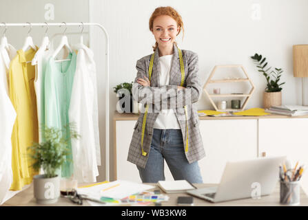 Talented young dressmaker posing in workshop, free space Stock Photo