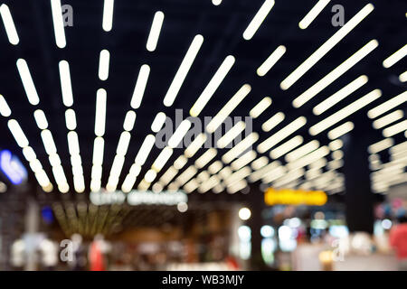 Abstract blurred shopping mall or department store defocused interior. Dark illuminated urban glowing background Stock Photo