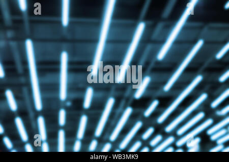 Abstract blurred blue neon led light lamp stripes on mall ceiling or roof. Perspective striped futuristic loft modern background Stock Photo