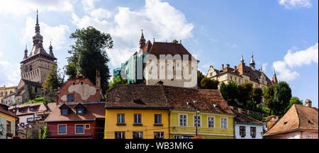 Sighisoara, Romania - 2019. Beautiful view of colorful houses and Tower Clock (Turnul cu ceas) in Sighisoara citadel. Stock Photo