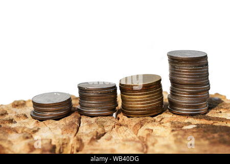 Four rows of coin on tree stump isolated on white background , Pile coins in a graph pattern soared , Growth by amount of savings Stock Photo