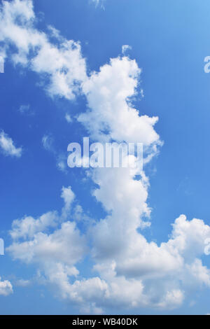 Bright cloud shape like The women standing and  cross one's arm on beautiful blue sky , Fluffy clouds formations at tropical zone Stock Photo