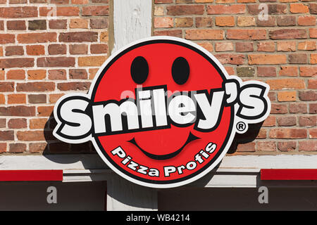 Stade, Germany - August 22, 2019: Signage at wall identifying a Smiley’s pizza delivery service branch Stock Photo