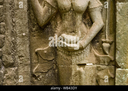 Carved sandstone bas-relief Apsaras (celestial maidens) at Ta Prohm. Cambodia. Stock Photo