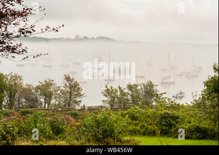 Schull, West Cork, Ireland. 24th Aug, 2019. The fog envelops the boats in Schull Harbour on an overcast but humid day in West Cork. Rain will move in to the area this afternoon with highs of 17 to 19C. Credit: Andy Gibson/Alamy Live News Stock Photo