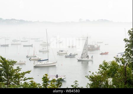 Schull, West Cork, Ireland. 24th Aug, 2019. The fog envelops the boats in Schull Harbour on an overcast but humid day in West Cork. Rain will move in to the area this afternoon with highs of 17 to 19C. Credit: Andy Gibson/Alamy Live News Stock Photo