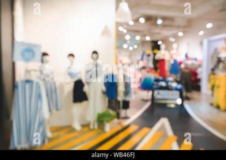 Blurred image of boutique display with mannequins in fashionable dresses for background. On sale at a clothing store in a modern shopping mall. Big Sa Stock Photo